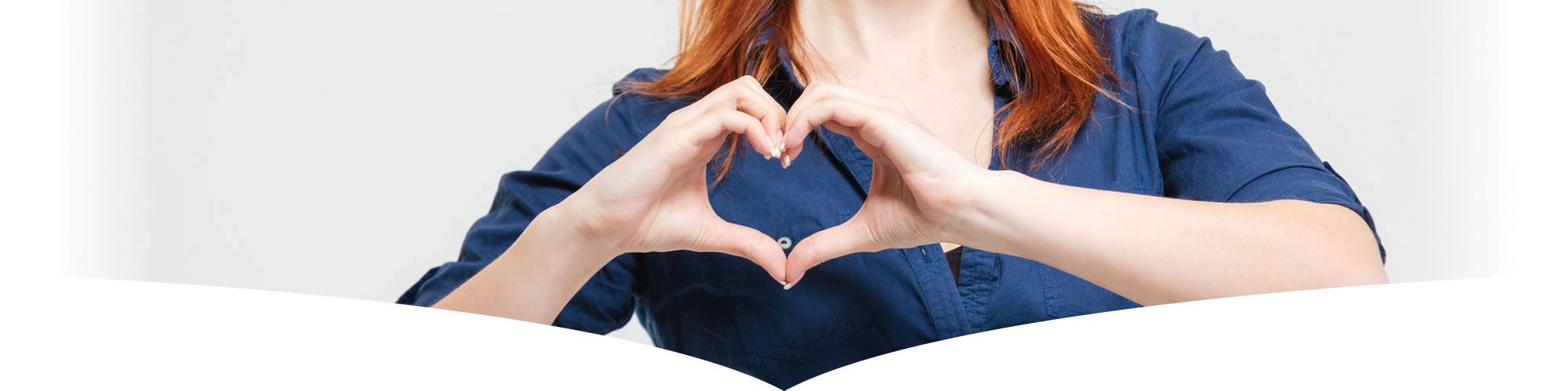 Lady showing heart symbol whilst giving testimonial